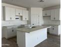 Bright kitchen with white cabinets, large island and stainless steel sink at 24105 W Bowker St, Buckeye, AZ 85326