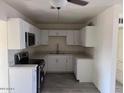 Updated kitchen featuring modern white cabinets and countertops at 3143 W Glendale Ave, Phoenix, AZ 85051