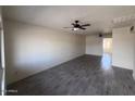 Open-concept living room featuring new flooring and a ceiling fan at 3143 W Glendale Ave, Phoenix, AZ 85051