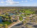 Picturesque aerial view of the community showcasing lush parks, serene lakes, and stunning mountain backdrops at 3781 N Camden Dr, Florence, AZ 85132