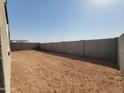 Expansive backyard enclosed by a block fence, offering ample space for customization and outdoor activities at 3781 N Camden Dr, Florence, AZ 85132