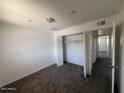 Bedroom with dark carpet, a closet with doors and neutral walls at 4332 W Ocotillo Rd # 206, Glendale, AZ 85301