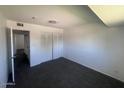 Bedroom with dark carpet, closet with sliding doors, and a neutral wall color at 4332 W Ocotillo Rd # 206, Glendale, AZ 85301