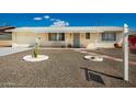 Inviting single-story home with desert landscaping, walkway, and covered porch at 509 N 56 St, Mesa, AZ 85205