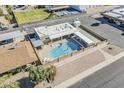 Aerial view showcasing the community pool, spa, clubhouse, and manicured green spaces, offering a resort-like experience at 6433 E University Dr, Mesa, AZ 85205