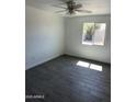 Bedroom featuring a large window that lets in natural light and tile floors at 1818 N 63Rd Ave, Phoenix, AZ 85035
