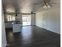 Open concept kitchen with granite counters, stainless steel sink, and tile flooring at 1818 N 63Rd Ave, Phoenix, AZ 85035