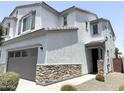 Charming two-story home with stone accents and a two-car garage showcasing modern curb appeal at 2339 E University Dr # 19, Mesa, AZ 85213