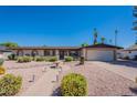 Inviting single-story home with a lush, drought-tolerant landscape and a charming front yard fountain at 2446 E Hale St, Mesa, AZ 85213