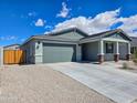 Single-story home featuring a gray color scheme, a two-car garage, and a spacious driveway at 24552 W Hilton Ave, Buckeye, AZ 85326