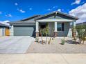 Inviting single-story home featuring a two-car garage, neutral color scheme, and landscaped front yard at 24552 W Hilton Ave, Buckeye, AZ 85326