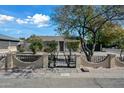 A charming single-story home, featuring a decorative fence with a secure gated entry for privacy and curb appeal at 2601 N 51St St, Phoenix, AZ 85008