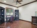 Elegant home office featuring rich wood flooring, a ceiling fan, and dark wood trim and cabinets at 2822 E Constance Way, Phoenix, AZ 85042