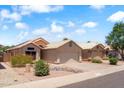 Street view of homes in a residential neighborhood with desert landscaping and neutral-colored exteriors at 316 W Kelton Ln, Phoenix, AZ 85023