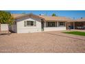 Attractive single-story home with fresh exterior paint, neat gravel landscaping, and mature trees at 3209 N 20Th Pl, Phoenix, AZ 85016