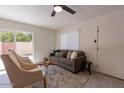 Bright living room featuring modern decor, stylish furnishings, and sliding glass doors with access to the backyard at 4268 N 68Th Ave, Phoenix, AZ 85033