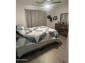 A cozy bedroom with a queen-sized bed, stylish linens, and wood-look flooring at 4729 W Eva St, Glendale, AZ 85302