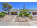 Inviting home showcasing a desert-style front yard, a covered carport, and mature desert landscaping at 5335 N 78Th St, Scottsdale, AZ 85250