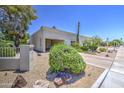 Well-kept home exterior featuring low-maintenance desert landscaping and attached carport for convenient parking at 5335 N 78Th St, Scottsdale, AZ 85250