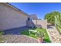 Low maintenance backyard with artificial grass, patio seating and gravel landscaping at 14304 W Coronado Rd, Goodyear, AZ 85395