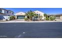 A charming house with stucco walls, desert landscaping, and a green garage door at 14304 W Coronado Rd, Goodyear, AZ 85395