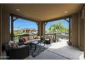 Inviting covered porch features outdoor seating and neighborhood views at 20702 W Hillcrest Blvd, Buckeye, AZ 85396