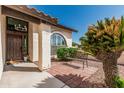 Inviting front entrance with a quaint seating area, mature landscaping, and covered porch at 401 E Barbara Dr, Tempe, AZ 85288