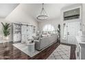 Bright and airy living room with soaring ceilings, a large arched window, and hardwood floors at 401 E Barbara Dr, Tempe, AZ 85288