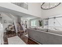 Open-concept living area features hardwood floors, a modern staircase, and comfortable seating at 401 E Barbara Dr, Tempe, AZ 85288