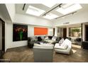 Spacious living room featuring contemporary furnishings, skylights, and artistic decor, perfect for relaxation and entertainment at 4525 N 66Th St # 112, Scottsdale, AZ 85251