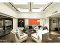 Bright living room with skylights, modern furniture, and sleek design, creating a comfortable and stylish ambiance at 4525 N 66Th St # 112, Scottsdale, AZ 85251