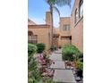 Paver walkway with lush plants leading to an inviting courtyard entry at 5640 E Bell Rd # 1099, Scottsdale, AZ 85254