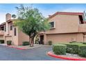 Attractive townhome with a well-maintained landscape, a tile roof, and mature trees at 5640 E Bell Rd # 1099, Scottsdale, AZ 85254