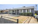 Well-maintained single-story home with a covered porch and landscaped yard at 6147 W Rose Cir, Phoenix, AZ 85033