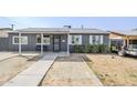 Inviting single-story home with gray brick and landscaped front yard at 6147 W Rose Cir, Phoenix, AZ 85033