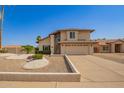 Charming two-story home with a well-manicured lawn and an attached two-car garage at 7709 W Hearn Rd, Peoria, AZ 85381