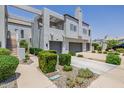 Modern townhome complex with private garages, lush landscaping, and architectural details at 7710 E Gainey Ranch E Rd # 115, Scottsdale, AZ 85258