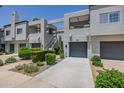 Contemporary townhouse complex featuring private garages and well-maintained landscaping at 7710 E Gainey Ranch E Rd # 115, Scottsdale, AZ 85258