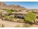 Rear exterior features a covered patio, well manicured lawn with mature trees, and desert views at 16224 S Reserve Dr, Phoenix, AZ 85045