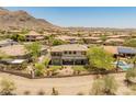 Rear exterior showcases mature landscaping, a fenced in yard, and mountain views nearby at 16224 S Reserve Dr, Phoenix, AZ 85045