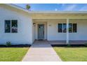 Inviting covered front porch with fresh landscaping, a stylish front door, and enhanced curb appeal at 1917 E Jensen St, Mesa, AZ 85203