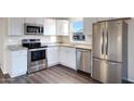 Modern kitchen featuring stainless steel appliances, granite countertops, and white cabinets at 320 E Mckellips Rd # 44, Mesa, AZ 85201
