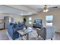 Inviting living room with modern furnishings, including a plush sofa, accent chair, and entertainment center at 320 E Mckellips Rd # 44, Mesa, AZ 85201