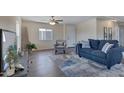 Well-lit living room featuring a comfortable blue sofa, an accent chair, and stylish decor at 320 E Mckellips Rd # 44, Mesa, AZ 85201