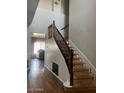 A grand entryway features an ornate staircase and wood floors at 41763 W Mano Pl, Maricopa, AZ 85138