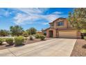Charming two-story home with neutral stucco, landscaped front yard, and a spacious driveway leading to an attached two-car garage at 41763 W Mano Pl, Maricopa, AZ 85138