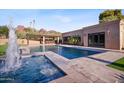 Beautiful backyard with a pool, spa, fountains, covered bar area and desert landscaping with mountain views at 4518 E Solano Dr, Phoenix, AZ 85018