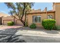 Street view of charming two-story home with desert landscaping and a tile roof at 7955 E Chaparral Rd # 17, Scottsdale, AZ 85250