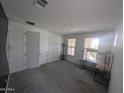 A tidy bedroom with neutral walls, carpet flooring, ample natural light, and a wardrobe and desk at 9548 E Rainbow Ave, Mesa, AZ 85212