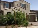 Inviting two-story home with lush landscaping and a paved driveway leading to a two-car garage at 9548 E Rainbow Ave, Mesa, AZ 85212